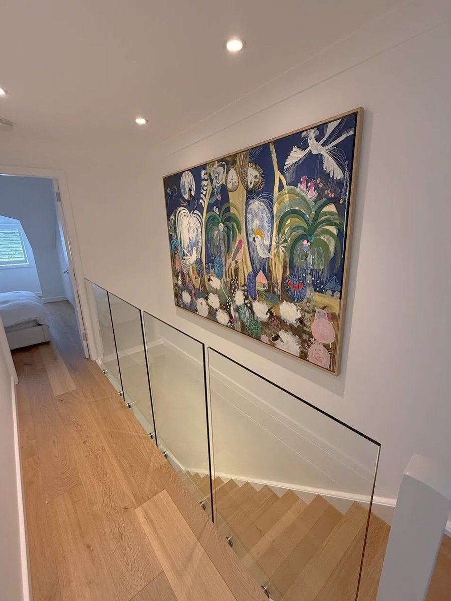 After: the upstairs landing, with a glass balustrade and oak stairs