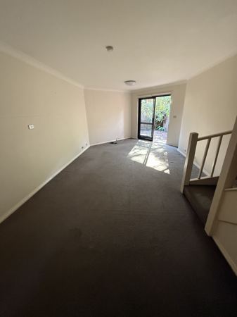 Before: the living room, with dark carpet and dated finishes